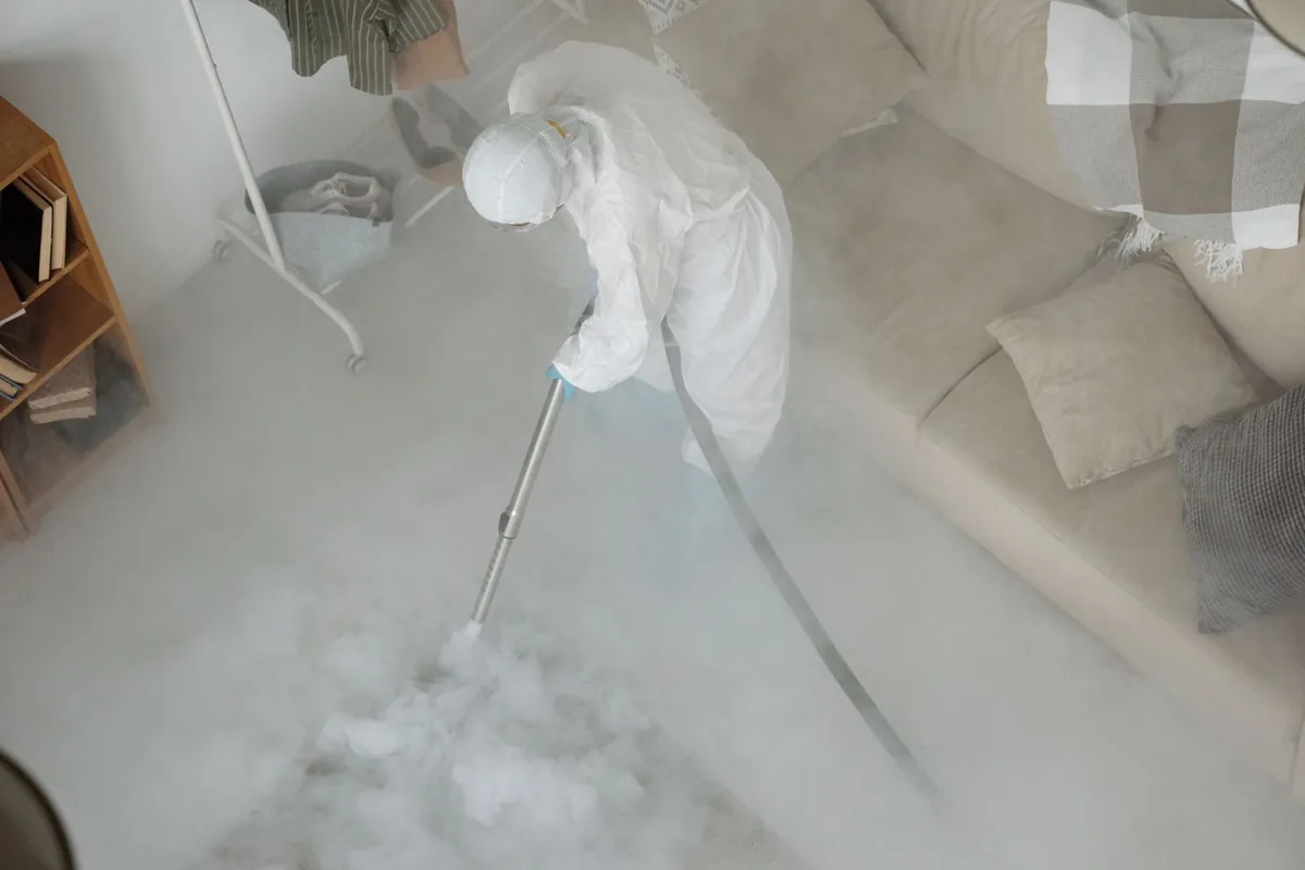 Biohazard cleanup technician in protective equipment, Tucumcari, NM
